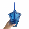 Blue star-shaped tumbler cup with blue straw on white background