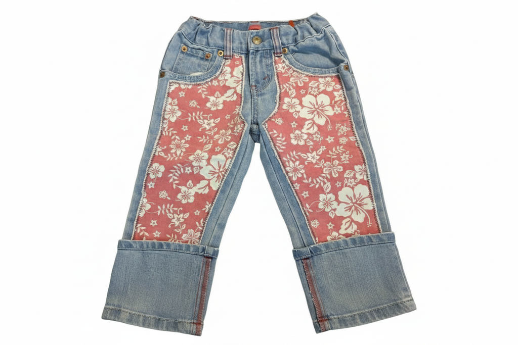Girls light wash denim jeans with pink Hawaiian floral panel insets - front view on white background
