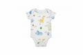 White baby onesie with pastel dinosaur print on white background